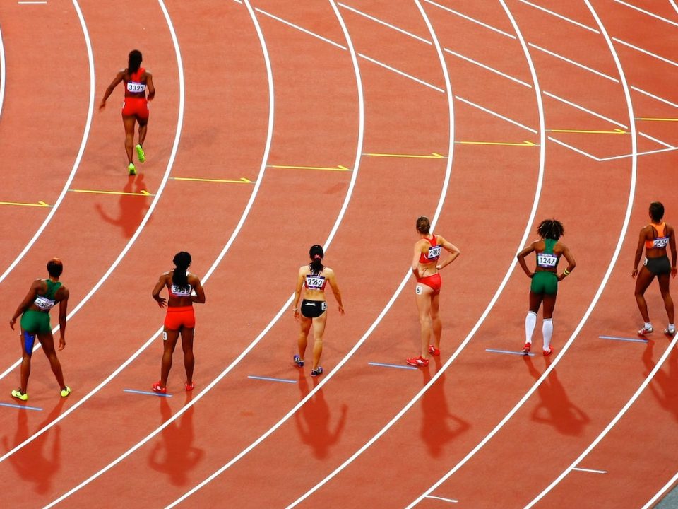 women running on race track during daytime
